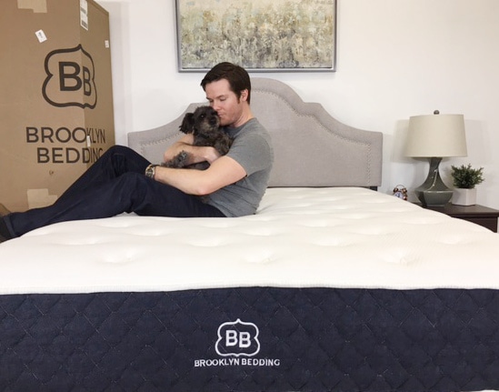 guy and dog sitting on brooklyn signature