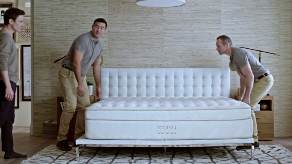 three men around a mattress
